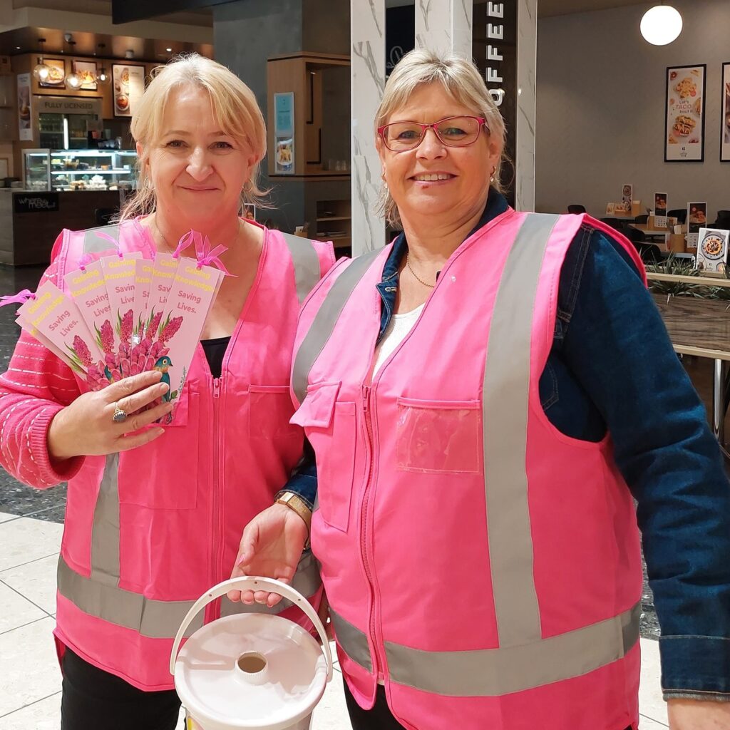 Waikato Sunrise members in high vis vests holding fundraising bucket