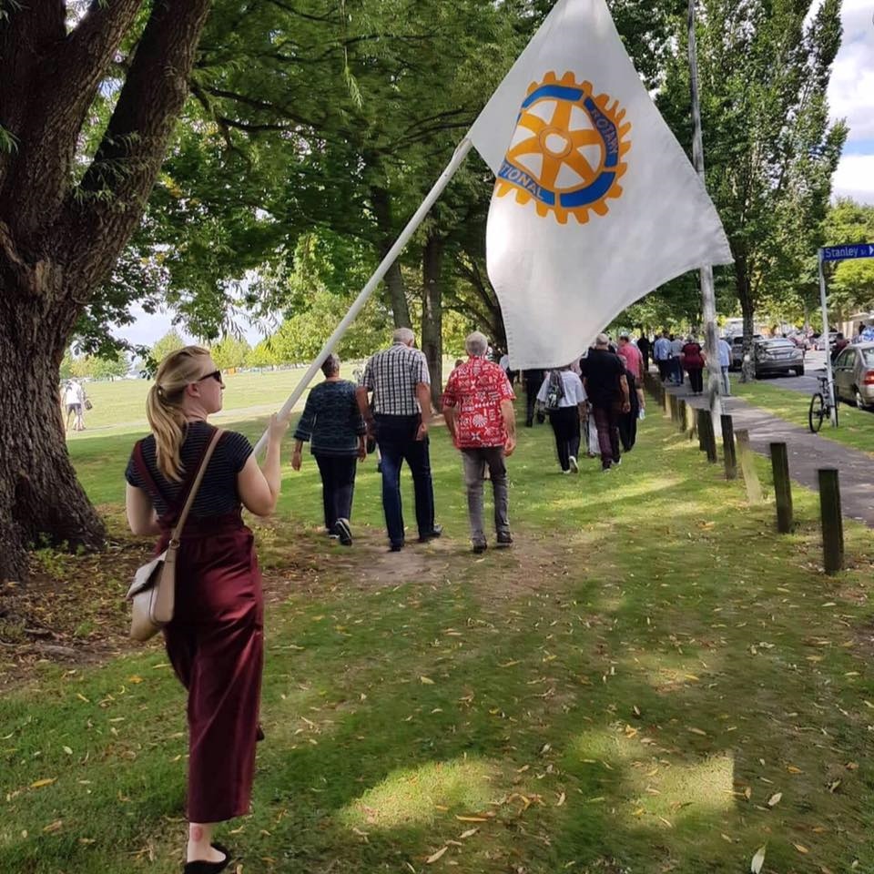 Waikato Sunrise member holding Rotary Flag